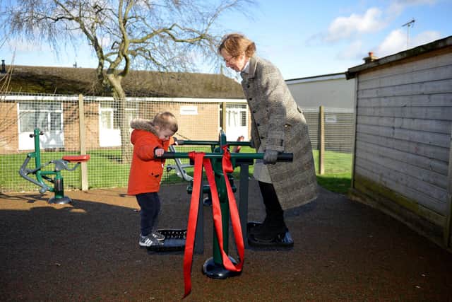 Official opening of outdoor gym equipment at Intake Farm Primary and Nursery School, Mansfield.  Pictured is County Councillor Diana Meale trying out the new equipment