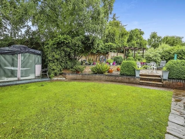A final image of the stunning garden at the £600,000-plus property in Selston. It includes a lawn and a water fountain.