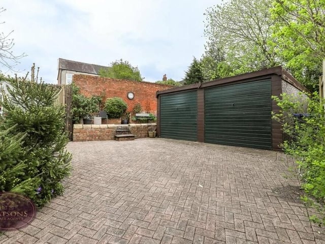 At the end of the driveway is this detached double garage with up-and-over doors,