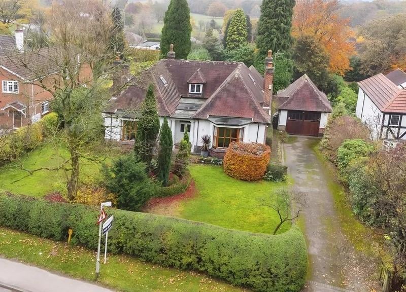 Outside, the property truly shines with established gardens that wrap around the front, side, and rear of the home.
