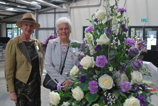 Presidents' Lady Ingrid Barker and Jane Walden, chief steward for floral art, with the best in show, entitled Congratulations, by Cliff Richards.