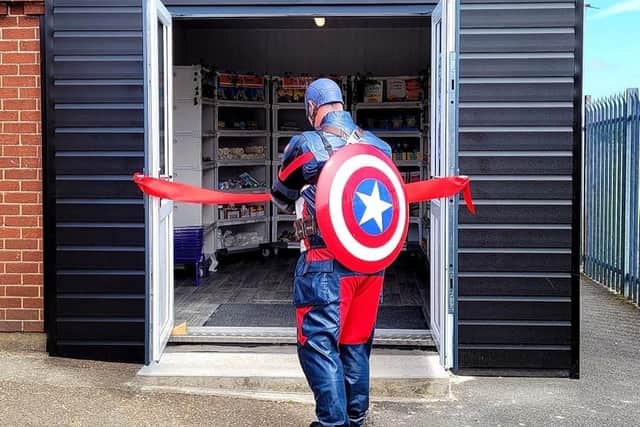 The mysterious superhero 'Captain Mansfield' cuts the ribbon at the Rainworth Social Supermarket opening