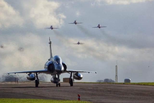 A photograph of an Indian Air Force, Mirage 2000, with the Red Arrows taking off behind them. Again the Indian Air Force have been taking place in Exercise Cobra Warrior.