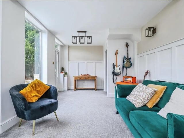 A second reception room provides even more space, with two sets of patio doors opening onto the garden
