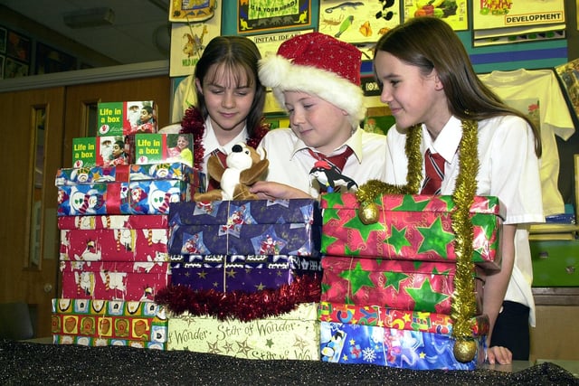 Hungerhill School helped two Christmas charities in 2002 the Samaritan's Purse "Operation Christmas Child" Shoebox Appeal and the Children In Distress "Life in a Box"-small change equals big difference appeal. Our picture shows pupils, from left, Vicky Johnson, aged 12, Jonathan Preston and Charlotte Fowkes, both aged 11, with some of the boxes and donations.