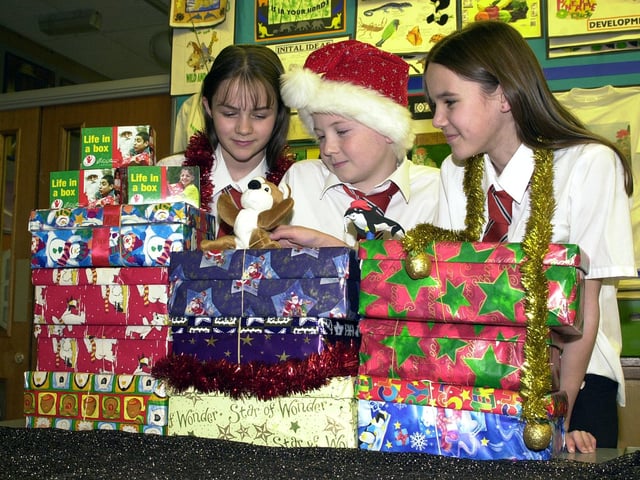 Hungerhill School helped two Christmas charities in 2002 the Samaritan's Purse "Operation Christmas Child" Shoebox Appeal and the Children In Distress "Life in a Box"-small change equals big difference appeal. Our picture shows pupils, from left, Vicky Johnson, aged 12, Jonathan Preston and Charlotte Fowkes, both aged 11, with some of the boxes and donations.