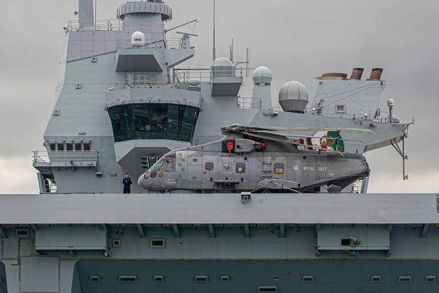 HMS Queen Elizabeth pictured with a Merlin helicopter on her flight deck as she departed Portsmouth on September 9. Picture: Habibur Rahman