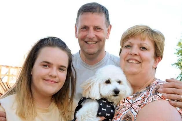 Mick Bonser pictured with his wife Karen, daughter Hannah and assistance dog Benji.