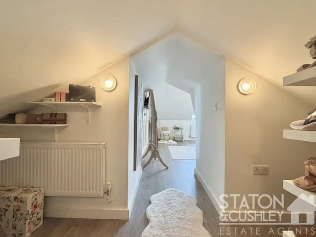 The second bedroom benefits from a dedicated dressing area together with access to useful additional storage space, offering both comfort and practicality.