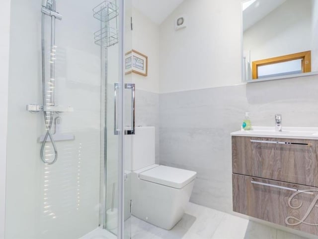 The master bedroom also has access to this en suite bathroom, which is the epitome of style. It is fitted with an enclosed shower, wall-hung wash hand basin with vanity unit and a low-flush WC. There is also the added benefit of a digitally-controlled thermostat.