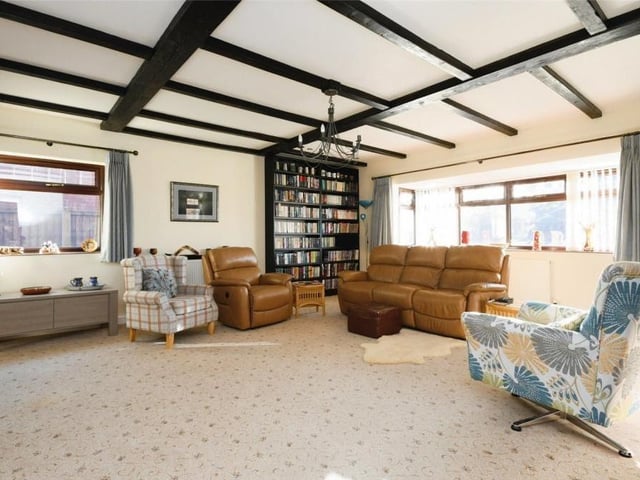 The lounge at the £500,000 bungalow can only be described as expansive. Look at the size of it! The room is stylish too and full of character thanks to its ceiling beams and large feature window facing the front of the property.