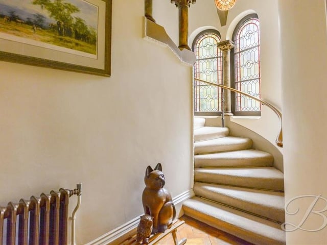 This curved staircase leads to the first floor, where all seven bedrooms are housed.