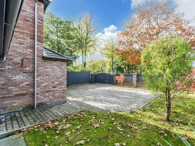 Returning to the front of the £535,000 house, behind the gated entrance sits a lawn and a block-paved driveway that provides off-street parking space for several cars.