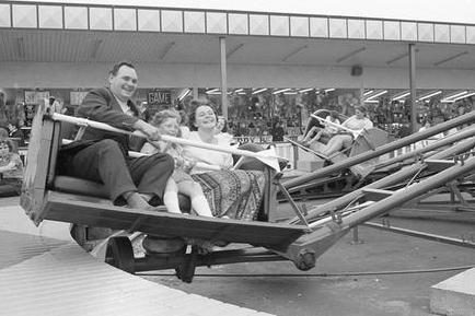 A family enjoys a funfair ride in Clipstone in 1973.