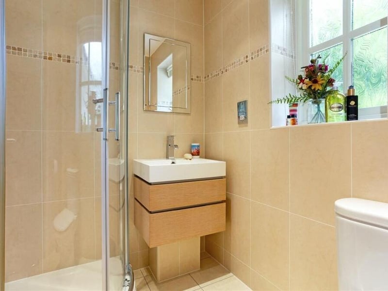 Here is the excellent en suite shower room that serves one of the bedrooms. It consists of a quadrant shower cubicle, a low-level WC, vanity hand wash basin and a chrome heated towel-rail.