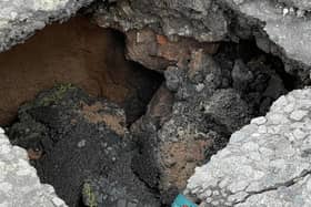 A large sinkhole has appeared in the road on Violet Hill following a collapsed drain