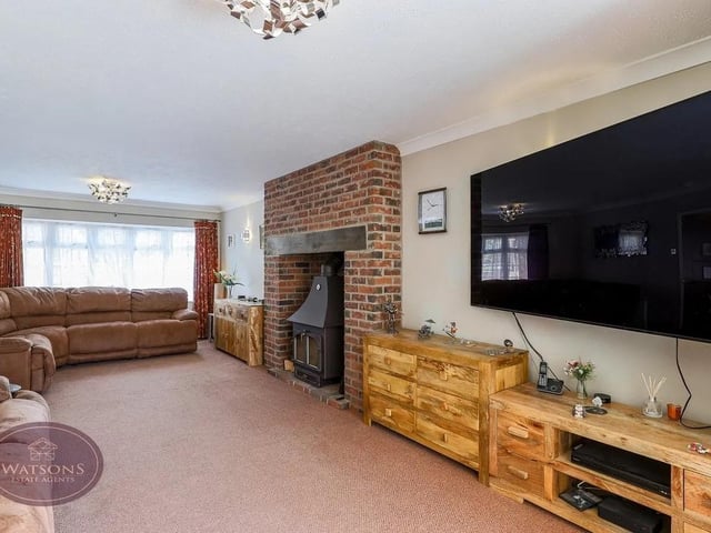 The lounge features a brick inglenook fireplace with multifuel burner, perfect for cosy evenings.