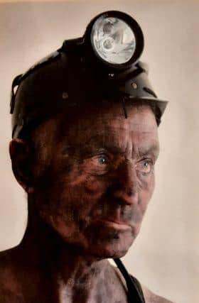 David performs his show dressed in miner’s gear with dirt smeared across his clothes.