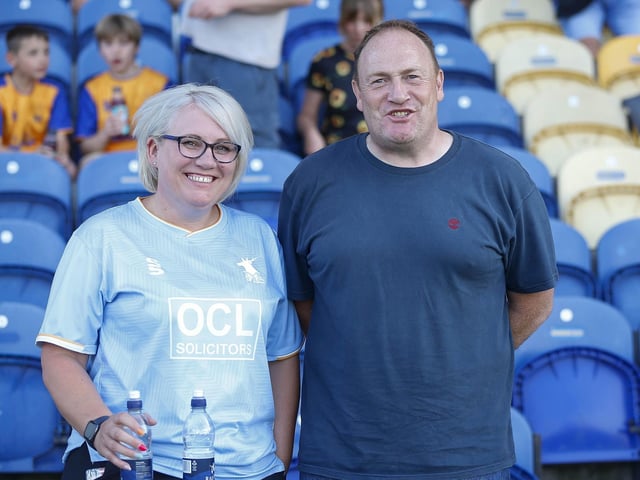 Mansfield Town fans watch the Carabao Cup first round match against Derby County.