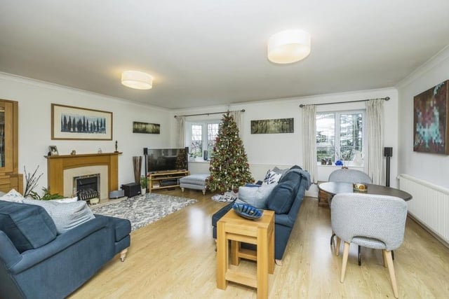 Our tour of the Dovecote Road property begins in this superb and spacious lounge. It includes a gas fireplace with oak feature surround, while French doors open out to the side of the bungalow.