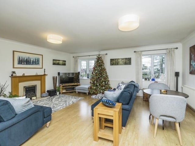 Our tour of the Dovecote Road property begins in this superb and spacious lounge. It includes a gas fireplace with oak feature surround, while French doors open out to the side of the bungalow.