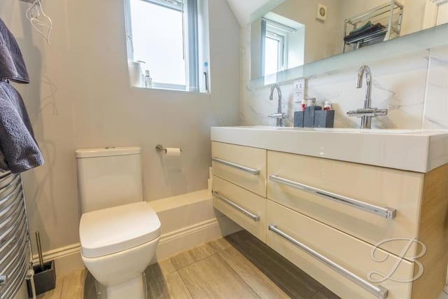 Three of the five bedrooms boast their own en suite facilities. Here is the first, complete with walk-in shower, low-flush WC, and his and hers wash hand basin