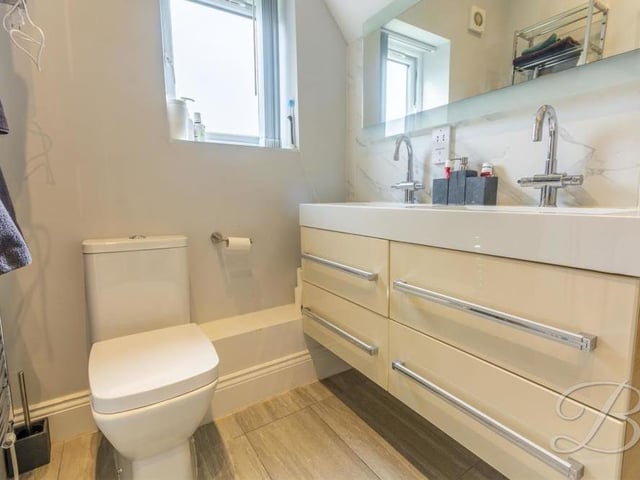 Three of the five bedrooms boast their own en suite facilities. Here is the first, complete with walk-in shower, low-flush WC, and his and hers wash hand basin