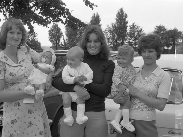 Can you spot any familiar faces watching the parade? Year: 1977.