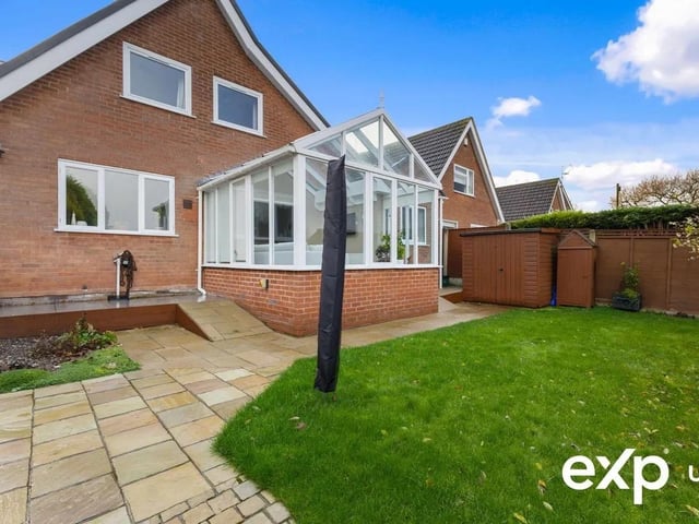 The rear garden is laid to lawn with a patio featuring a paved seating area. The garden is bordered with mature shrub bedding and planting and is all enclosed in a secure fence surround.
