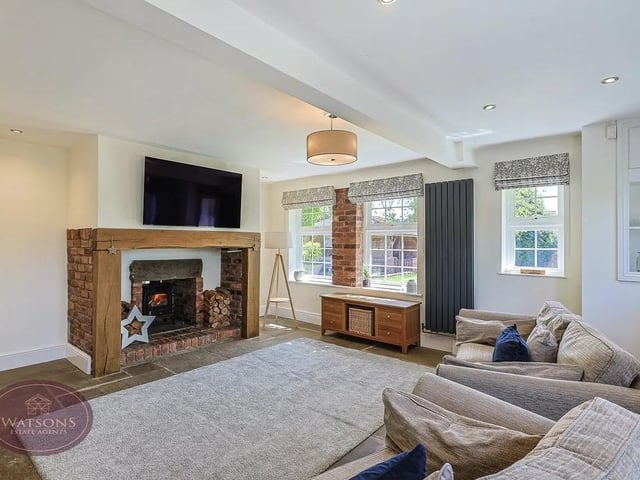 The welcoming snug with its impressive Inglenook fireplace sets the tone for the warmth and character found throughout the home.