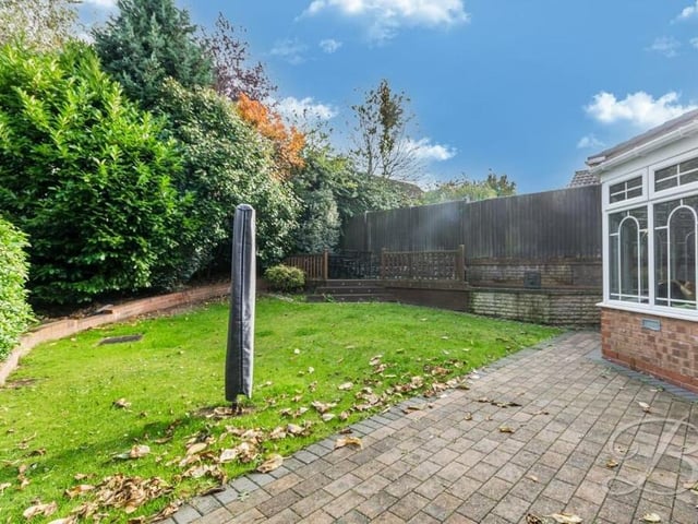 The rear garden, which also includes a raised decking area in the corner, is fully enclosed, guaranteeing privacy.