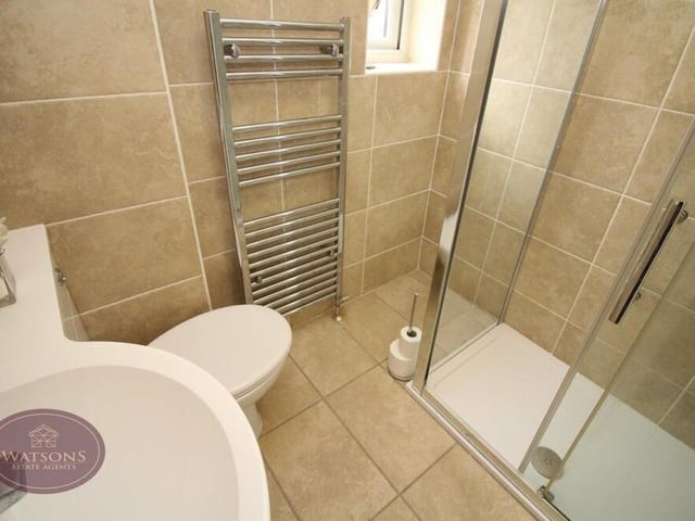 The three bedrooms on the first floor are served by this shower room. A modern three-piece suite comprises a shower cubicle with rainfall-effect shower, vanity sink unit and WC. There is also a chrome, heated towel-rail and tiled floor.