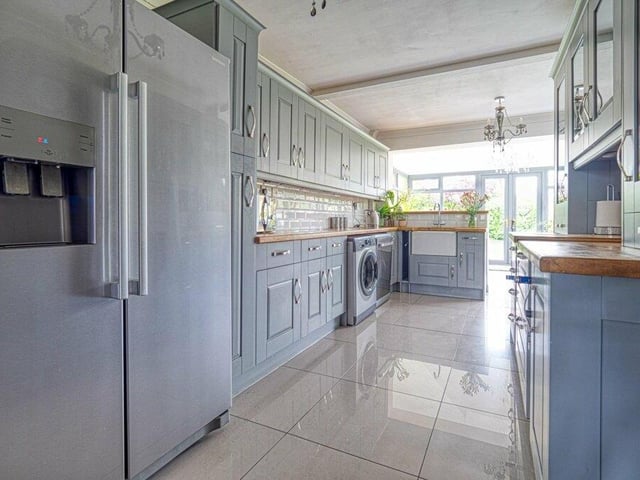The kitchen also has space for an American-style fridge/freezer and, as you walk along marble tiling with underfloor heating, it extends to a breakfast bar area.