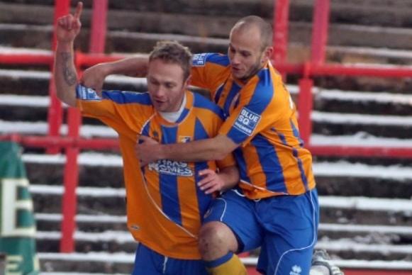 Paul Connor is congratulated by Adam Murray after opening the scoring.