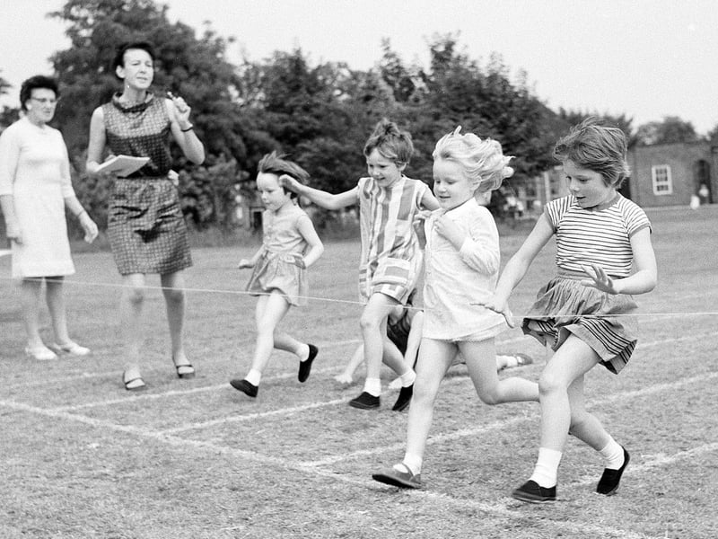 A teacher watches on at the finish line as children race in 1968 at Berry Hill School.