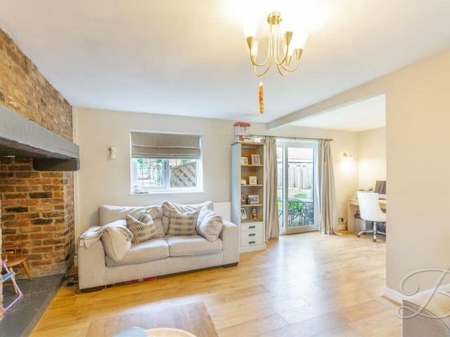 Just off the living room is an open-plan office space, complete with double sliding doors that lead out to the garden.