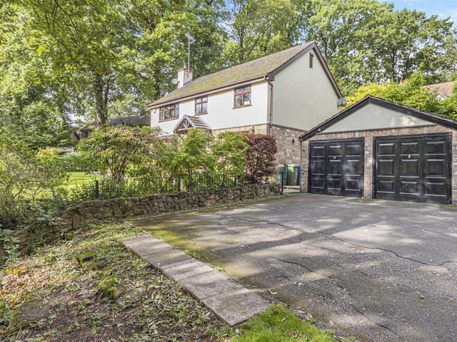At the side of the house is this detached double garage, with twin up-and-over doors. It is equipped with power and light.