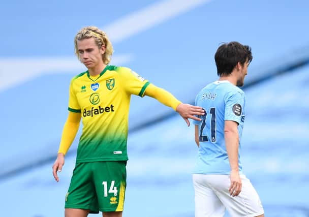 Todd Cantwell of Norwich City congratulates David Silva of Manchester City as he leaves the field on his final appearance for Manchester City during the Premier League match between Manchester City and Norwich City.