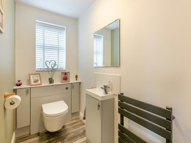 Even the downstairs toilet oozes style at the £395,000 Clipstone house. A modern two-piece suite comprises a wall-hung, low-flush WC with cupboards either side and a wash hand basin with mixer tap and a storage cupboard beneath.There is also a graphite heated towel-rail and a laminate floor.