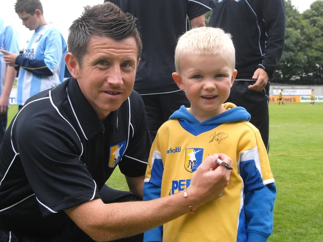Stags Captain Ryan Williams signs the shirt of four year old Coran Woodham at Field Mill.