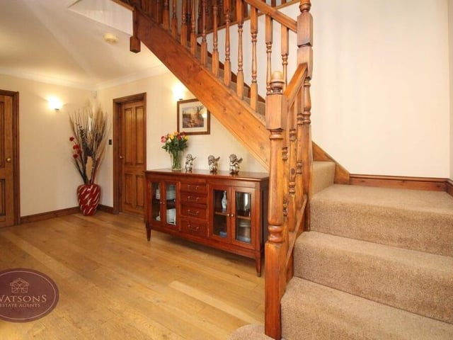 As we prepare to move up to the first floor, let's pass through the entrance hallway, which features a solid oak floor, cupbooard/cloakroom and staircase.