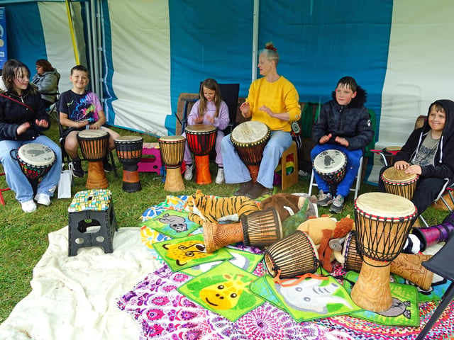 Having a go with drums at Ashfield's free family wellbeing roadshow.