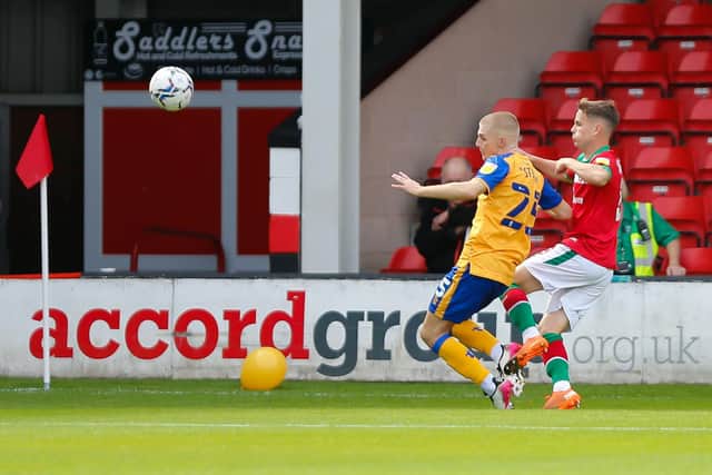 Stags midfielder Ryan Stirk battles for possession against Walsall at the West Midlands club's Banks's Stadium.