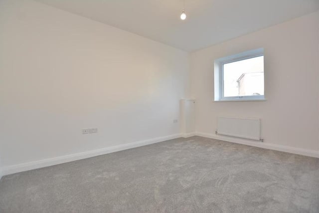 Bedroom number two is also a fine size. It includes a cupboard housing the consumer unit, plus a radiator, four double power points, a TV point and a double-glazed window to the front of the £250,000 property.