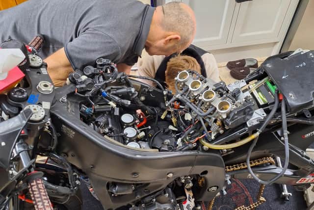 Lynden and his father Gary stripping the bike down in preparation for the season.