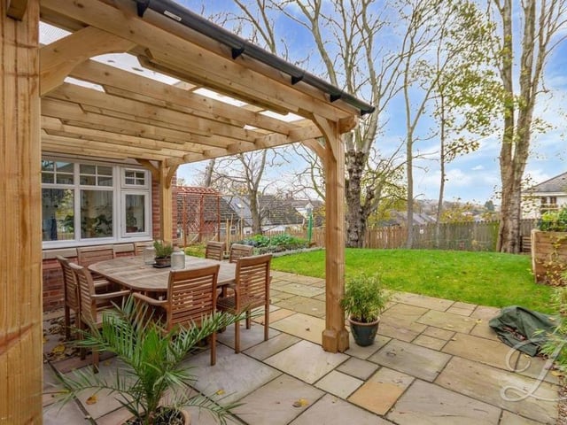 This delightful, covered patio seating area is ideal for entertaining family and friends on a warm summer's day.