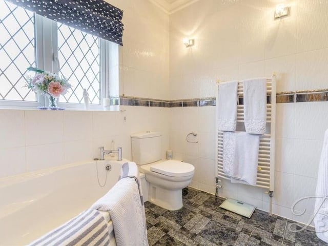 Here is an en suite bathroom on the ground floor of the Nottingham Road house which could prove handy if the lounge is turned into a bedroom. A four-piece suite includes a corner panelled bath, low-flush WC, heated towel-rail, tiled flooring and floor-to-ceiling downlights.