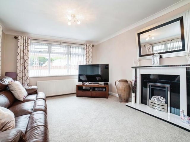 A feature of the lounge is its striking fireplace. It is a bright space too, thanks to windows facing the front and side of the property.