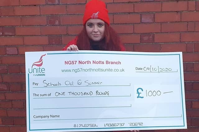 Phoebe Jade, one of School's Out For Summer's volunteers pictured with a cheque from Unite Union earlier this month.