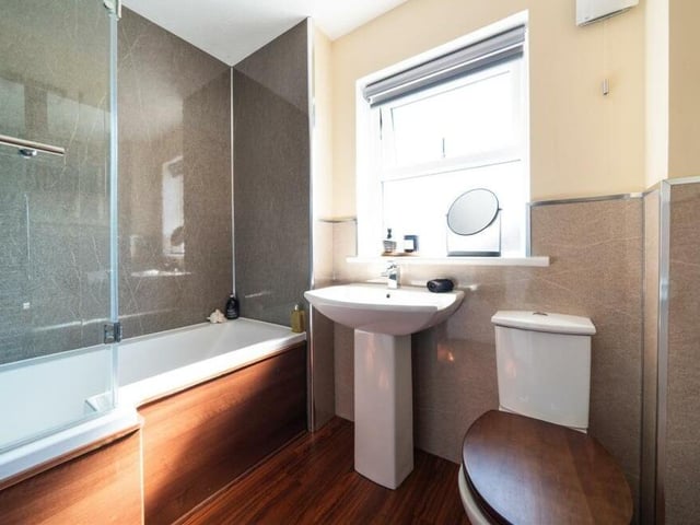 Before we take a look at the four bedrooms on the first floor, here is the family bathroom, complete with bath and overhead shower.